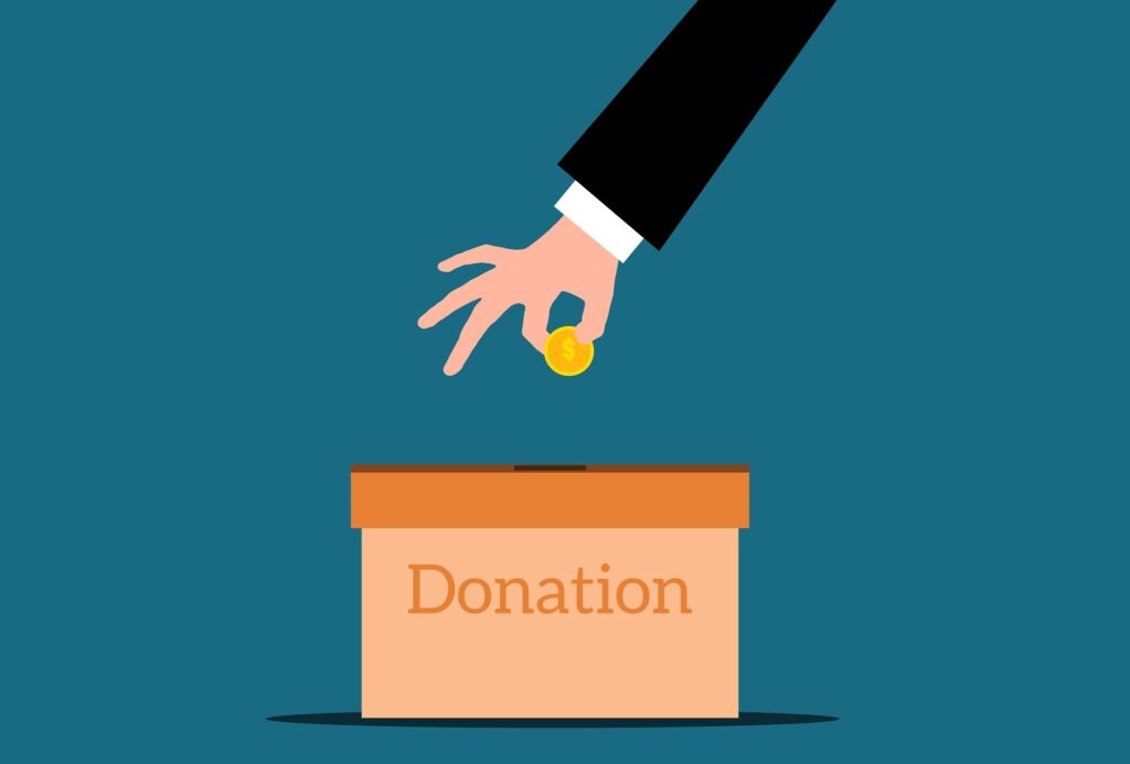 Cyan colored background with cartoon arm of someone dropping a coin into a donation box